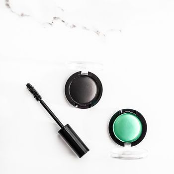 Cosmetic branding, blog and girly concept - Eyeshadows, black liner and mascara on marble background, eye shadows cosmetics as glamour make-up products for luxury beauty brand, holiday flatlay design