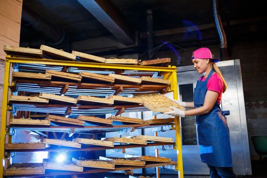 Macaroni factory. Spaghetti production. Raw pasta. Worker with a box of pasta. Girl works in the production of pasta