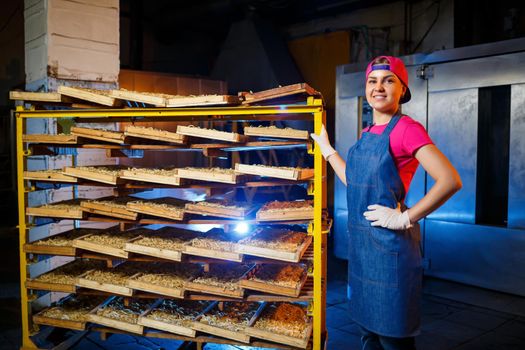 Make the noodles. Pasta factory. Spaghetti production. Raw pasta. Worker with a box of pasta. Girl works in the production of pasta