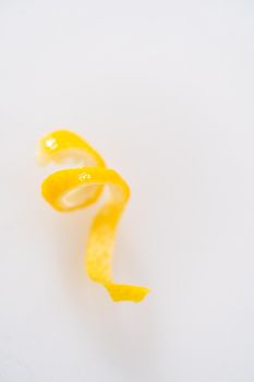 Preparing lemon swirls from the organic lemon to decorate the cocktail.