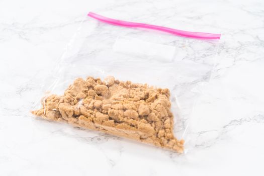 Light brown sugar on a marble counter top.