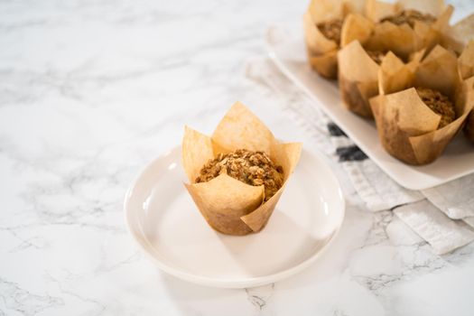 Freshly baked banana oatmeal muffins with oatmeal sugar topping.