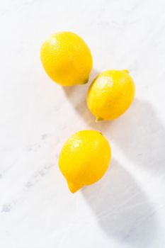 Preparing lemon swirls from the organic lemon to decorate the cocktail.