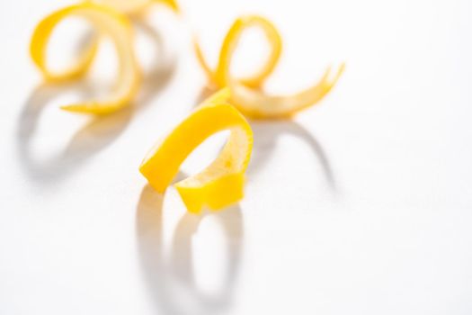 Preparing lemon swirls from the organic lemon to decorate the cocktail.