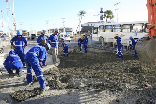 salvador, bahia, brazil - march 6, 2014: Workers working on street stretch revitalization works in Barra neighborhood in Salvador city.