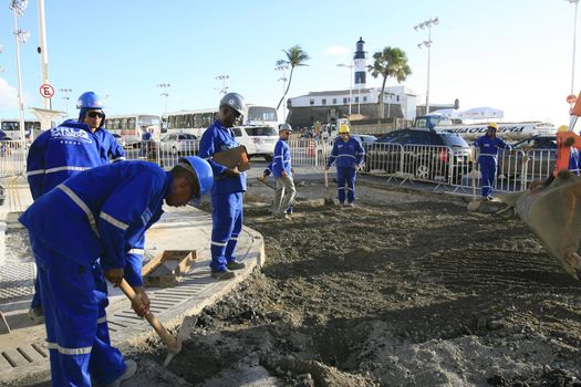 salvador, bahia, brazil - march 6, 2014: Workers working on street stretch revitalization works in Barra neighborhood in Salvador city.