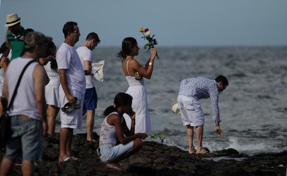 salvador, bahia / brazil - february 2, 2014: devotees and admirers of the orixa yemanja, a candomble entity, seen on the rio Vermelho beach, in the city of salvador, during a religious celebration.
