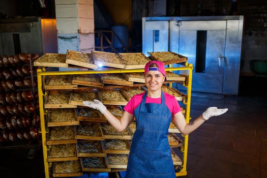 The girl is working on the production of spaghetti. Making noodles. Macaroni factory.