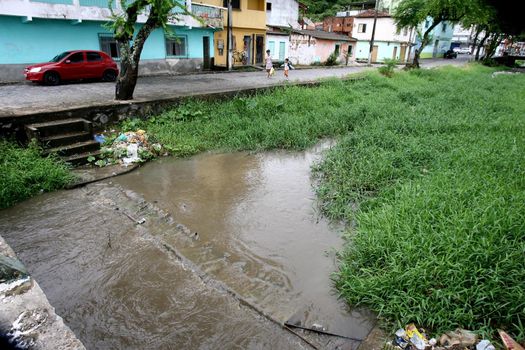 ilheus, bahia, brazil - march 5, 2012: water channel of a stream with polluted waters with domestic scum in the city of Ilheus.