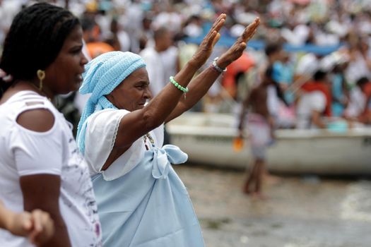salvador, bahia / brazil - february 2, 2014: devotees and admirers of the orixa yemanja, a candomble entity, seen on the rio Vermelho beach, in the city of salvador, during a religious celebration.
