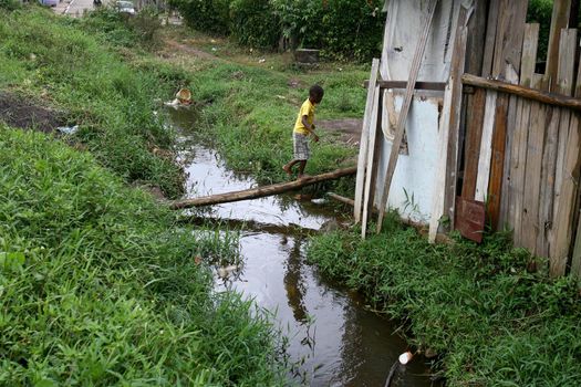 ilheus, bahia, brazil - march 5, 2012: water channel of a stream with polluted waters with domestic scum in the city of Ilheus.