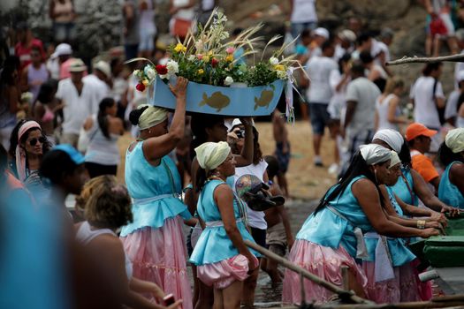 salvador, bahia / brazil - february 2, 2014: devotees and admirers of the orixa yemanja, a candomble entity, seen on the rio Vermelho beach, in the city of salvador, during a religious celebration.
