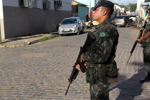 buerarema, bahia, brazil - february 14, 2014: Brazilian army soldiers patrol the streets of the city of Buerarema, during agrarian conflicts with Tupinamba Indians.