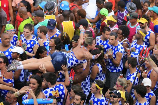salvador, bahia, brazil - march 4, 2014: Young man is seen carried by the crowd during a performance at the Camaleao Carnival Block in Salvador city.