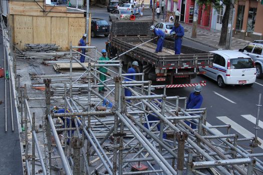 salvador, bahia, brazil - march 6, 2014: Workers working on dismantling the iron structure used to assemble the cabins used in the Salvador Carnival.