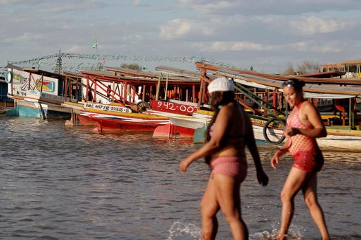 bom jesus da lapa, bahia, brazil - august 4, 2014: people are seen next to boats in the water of the Sao Francisco river in the city of Bom Jesus da Lapa.