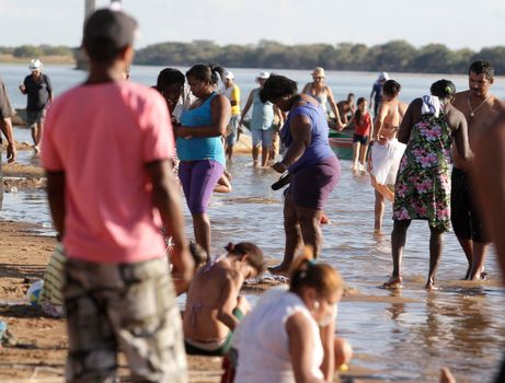 bom jesus da lapa, bahia, brazil - august 4, 2014: people are seen next to boats in the water of the Sao Francisco river in the city of Bom Jesus da Lapa.