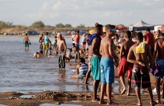 bom jesus da lapa, bahia, brazil - august 4, 2014: people are seen next to boats in the water of the Sao Francisco river in the city of Bom Jesus da Lapa.