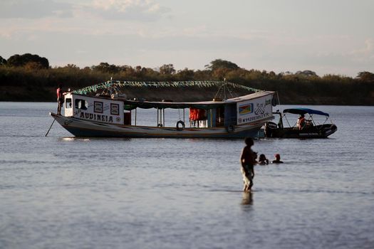 bom jesus da lapa, bahia, brazil - august 4, 2014: people are seen next to boats in the water of the Sao Francisco river in the city of Bom Jesus da Lapa.