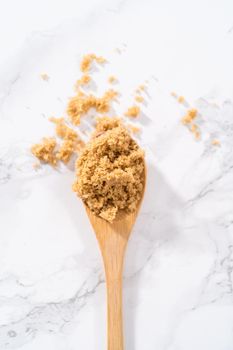 Light brown sugar on a marble counter top.