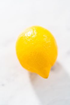 Preparing lemon swirls from the organic lemon to decorate the cocktail.