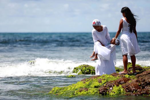 salvador, bahia / brazil - february 2, 2015: supporters of candomble are seen on the Rio Vermelho beach in the city of Salvador during a party in honor of Yemanja.