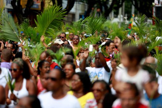 salvador, bahia, brazil - march 29, 2015: Catholics are seen carrying palm branches during procession of branches in Salvador city.