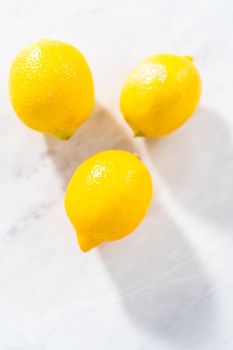 Preparing lemon swirls from the organic lemon to decorate the cocktail.