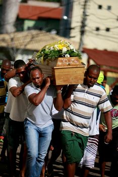 salvador, bahia / brazil - march 18, 2015: Family members carry the body of a relative during a procession for burial in the Municipal Cemetery of Itapua neighborhood in Salvador city.
