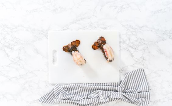Flat lay. Preparing raw lobster tails to make garlic lobster tails.
