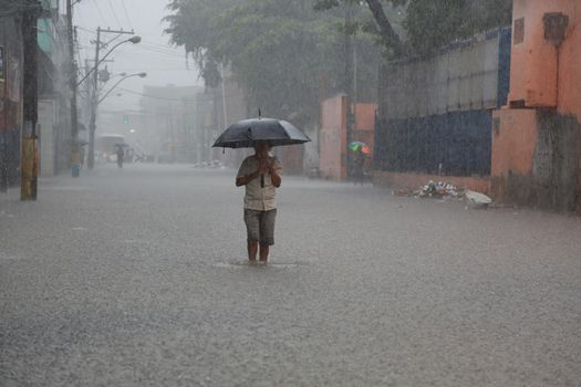 salvador, bahia / brazil - May 10, 2015: People are seen in a flooded area due to heavy rains in the city of Salvador.

