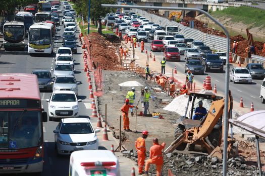 salvador, bahia / brazil - may 6, 2015: Workers work together to traffic vehicles on Avenida Antonio Carlos Magalhaes in works to expand the subway of Salvador.