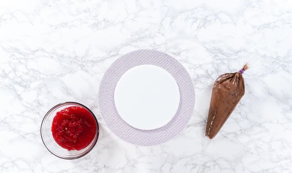 Flat lay. Covering chocolate cake with a crumb layer of chocolate buttercream frosting.