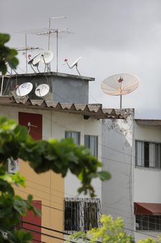 salvador, bahia, brazil - june 8, 2015: Pay TV antenna on the roof of a residential building in the Paralela neighborhood in the city of Salvador.

