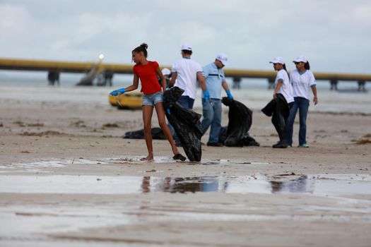 salvador, bahia, brazil - june 5, 2015: social action with volunteers cleaning the beach of Sao Tome de Paripe in the city of Salvador.