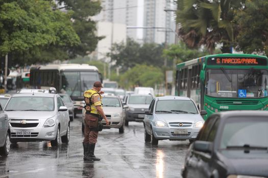 salvador, bahia / brazil - june 8, 2015: Transalvador transit agent seen guiding drivers during traffic jam on Avenida Antonio Carlos Magalhaes in the city of Salvador.