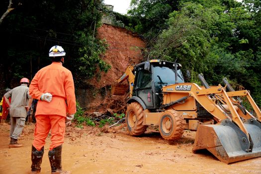 salvador, bahia / brazil - april 9, 2015: members of the fire department and volunteer people are seen during excavation of land that slid from a slope in the city of Salvador. the group seeks victims in the middle of the earth.


