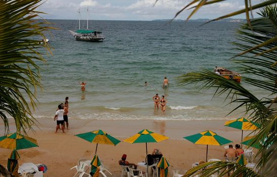 salvador, bahia / brazil - june 12, 2015: People are seen on the Nossa Senhora de Gaudalupe beach on Frades Island in th city of Salvador.