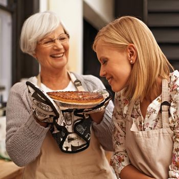 Smells like home. a young woman smelling the baked pie her grandmother made