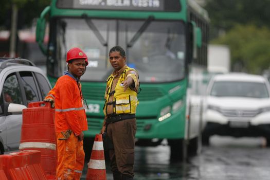 salvador, bahia / brazil - june 8, 2015: Transalvador transit agent seen guiding drivers during traffic jam on Avenida Antonio Carlos Magalhaes in the city of Salvador.