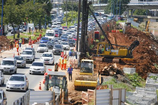 salvador, bahia / brazil - may 6, 2015: Workers work together to traffic vehicles on Avenida Antonio Carlos Magalhaes in works to expand the subway of Salvador.