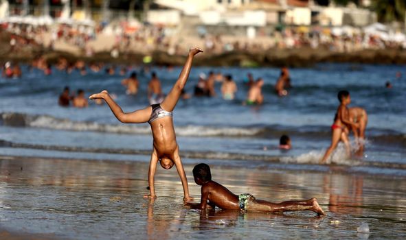 salvador, bahia / brazil - September 9, 2015: Children are seen playing on Itapua Beach in Salvador city.

