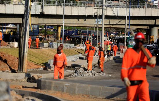 salvador, bahia, brazil - september 16, 2015: Workers are seen working on the construction of the bus station next to the metro station in Rótula do Abacaxi in the city of Salvador.