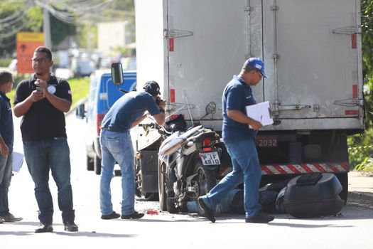 salvador, bahia / brazil - june 18, 2015: Technical Police forensic in traffic accident on Luiz Viana Avenue in Salvador. A man died while colliding a motorcycle in the bottom of a truck.