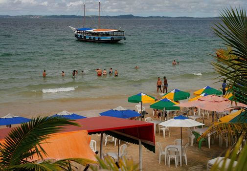 salvador, bahia / brazil - june 12, 2015: People are seen on the Nossa Senhora de Gaudalupe beach on Frades Island in th city of Salvador.