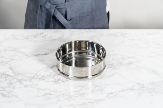 Greasing pressure cooker insert with cooking spray oil to cook no-peel hard-boiled eggs.