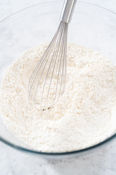 Mixing ingredients in a glass mixing bowl to bake July 4th bundt cake with chocolate stars.