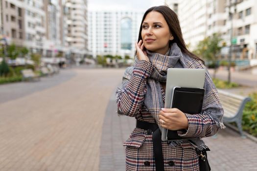 young business woman in a hurry on business with a laptop in her hands.