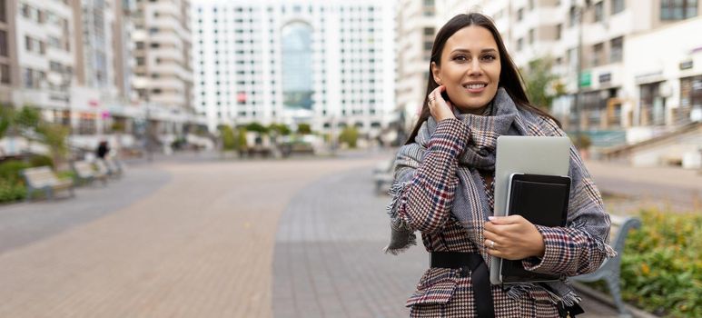 portrait of a successful woman entrepreneur on the background of a residential area.