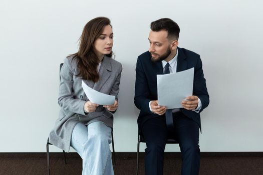 Exciting waiting for an interview of a man and a woman when applying for a job.